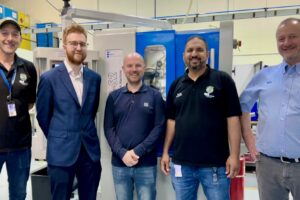 Engineers stood in front of their new machine